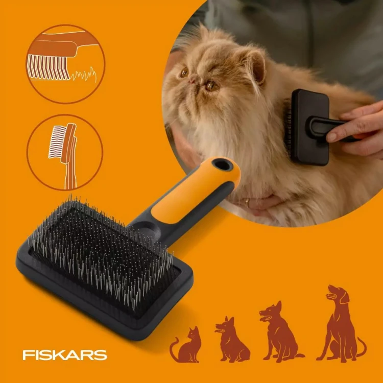 Szczotka rozczesująca Fiskars PET CARE używana do czesania długiej jasnej sierści kota